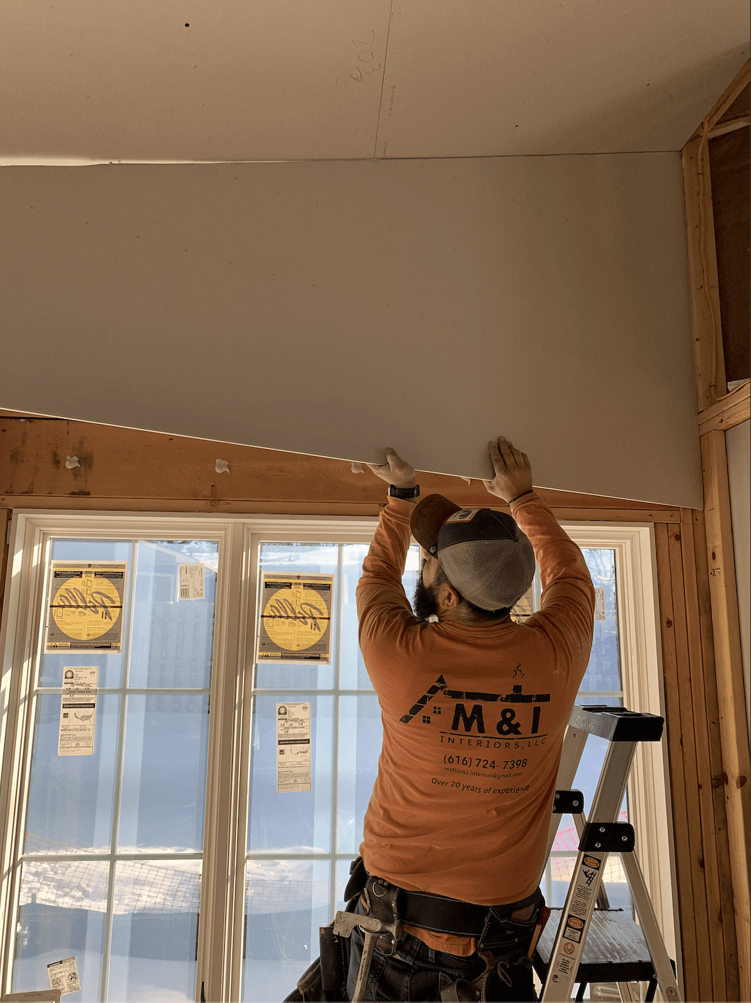 a man working on a ceiling in a house