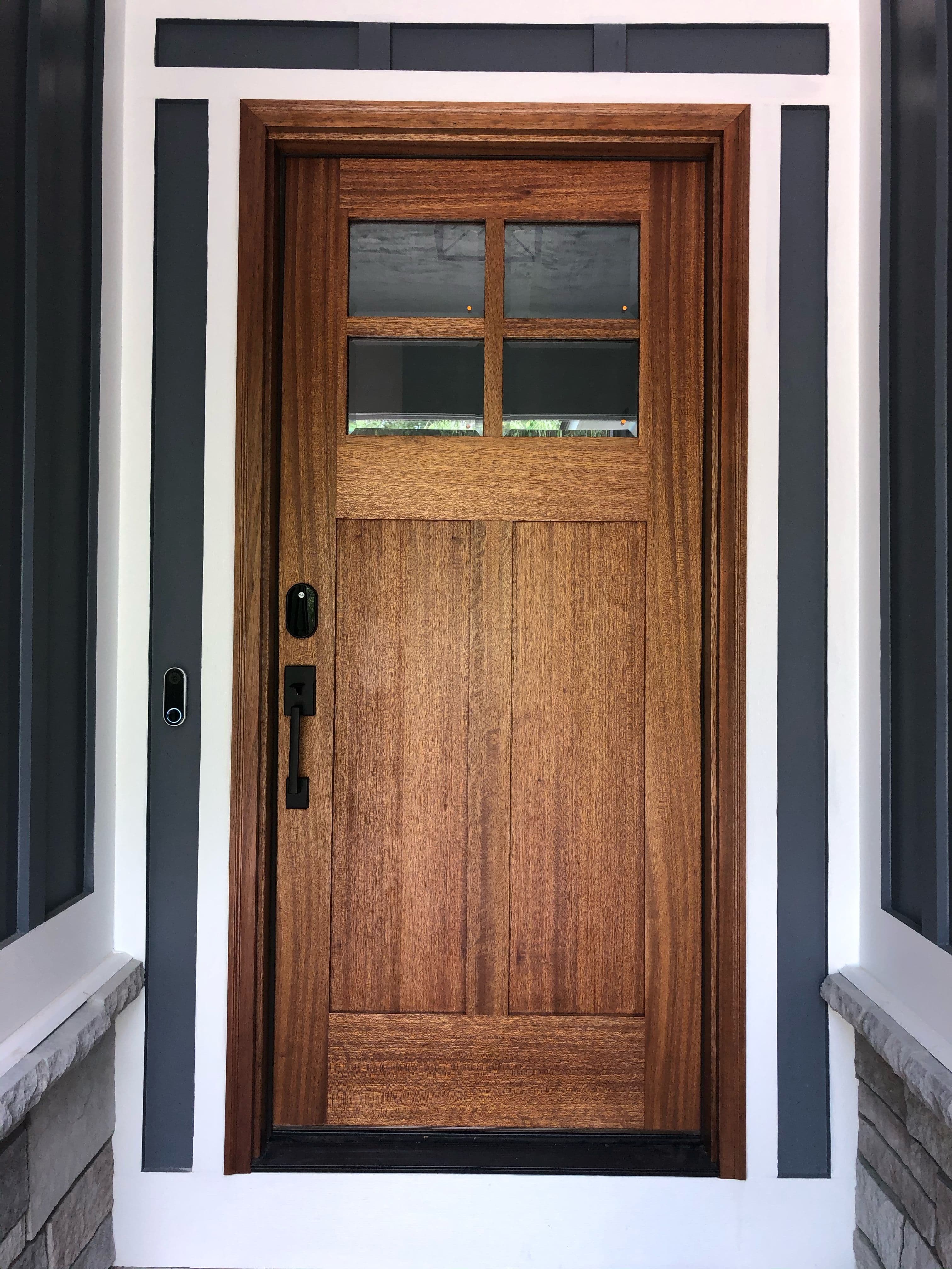 a long hallway with two doors leading to another room